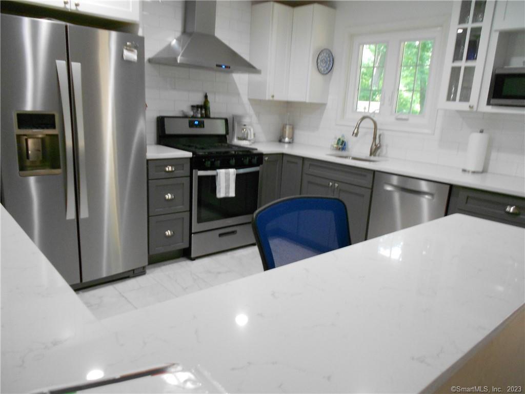 12 Allendale Road Old Saybrook, CT 06475 - Photo 7 of 36 a kitchen with stainless steel appliances a sink stove and refrigerator
