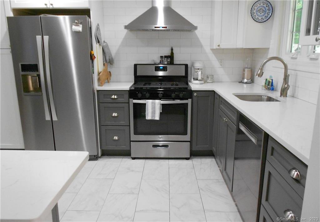 12 Allendale Road Old Saybrook, CT 06475 - Photo 9 of 36 a kitchen with stainless steel appliances a sink stove and refrigerator