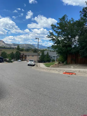 a backyard of a house with table and chairs plants