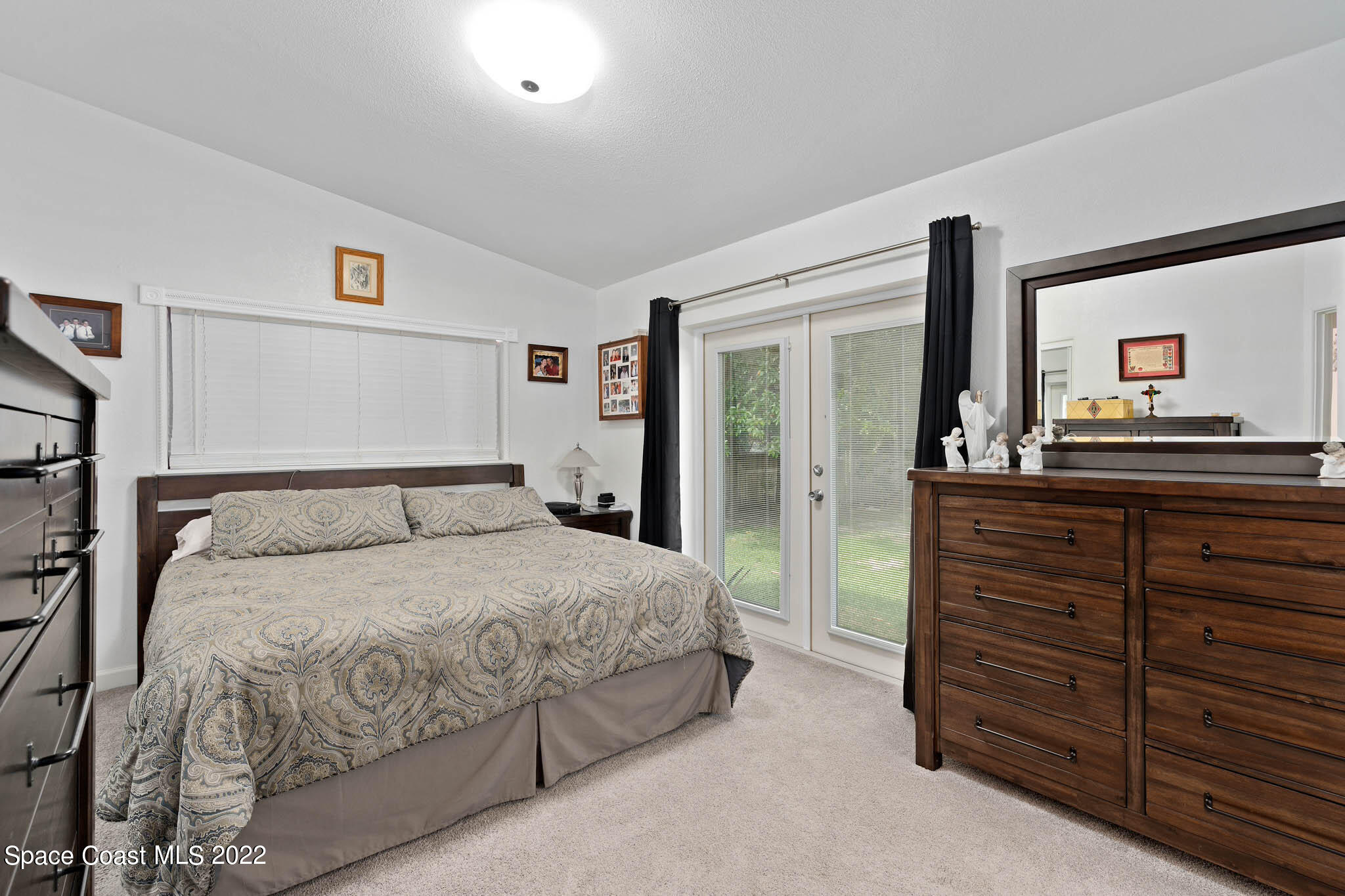 911 Bear Lake Road Apopka, FL 32703 - Photo 12 of 33 a bedroom with a bed and a dresser