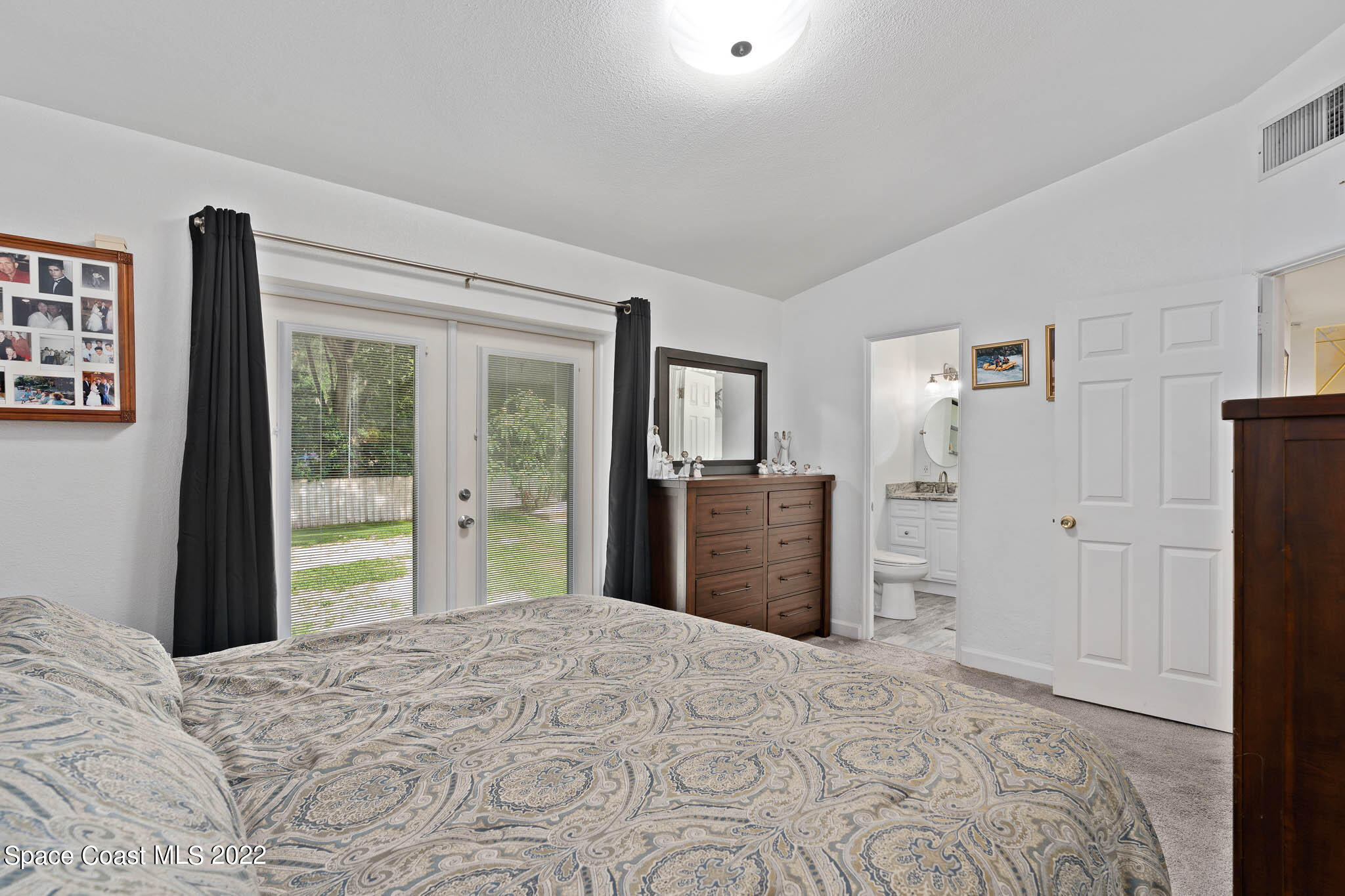911 Bear Lake Road Apopka, FL 32703 - Photo 14 of 33 a bedroom with a bed and dresser