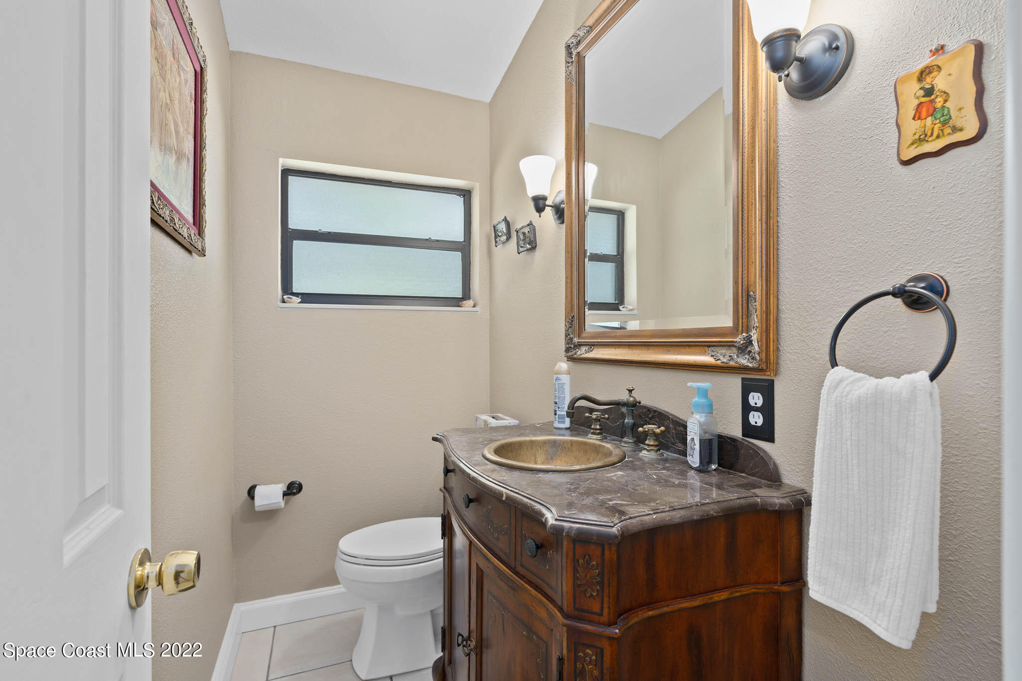 911 Bear Lake Road Apopka, FL 32703 - Photo 19 of 33 a bathroom with a granite countertop sink and a mirror