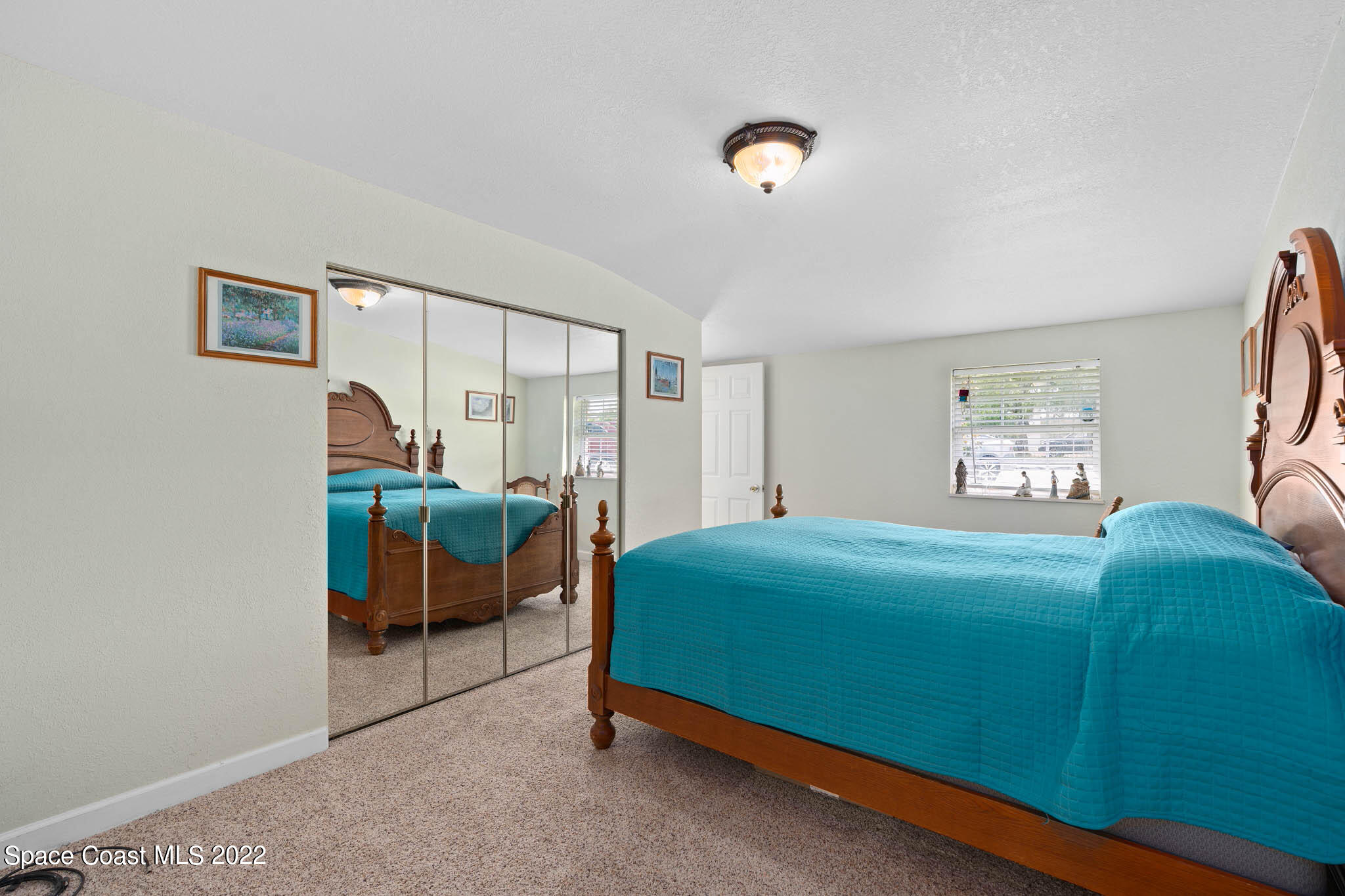 911 Bear Lake Road Apopka, FL 32703 - Photo 21 of 33 a bedroom with a bed and a table in it