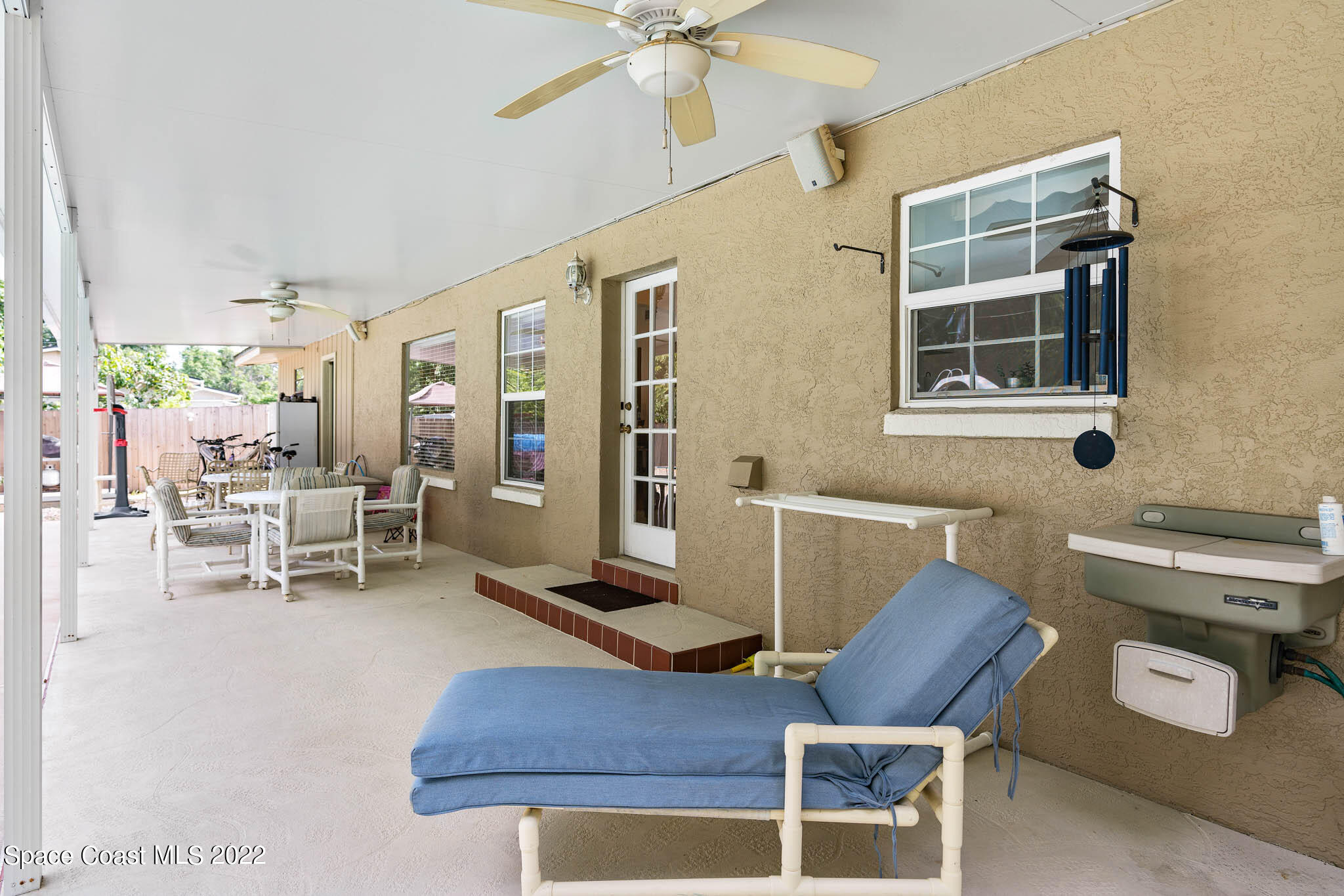 911 Bear Lake Road Apopka, FL 32703 - Photo 24 of 33 a living room with furniture a flat screen tv and outdoor view
