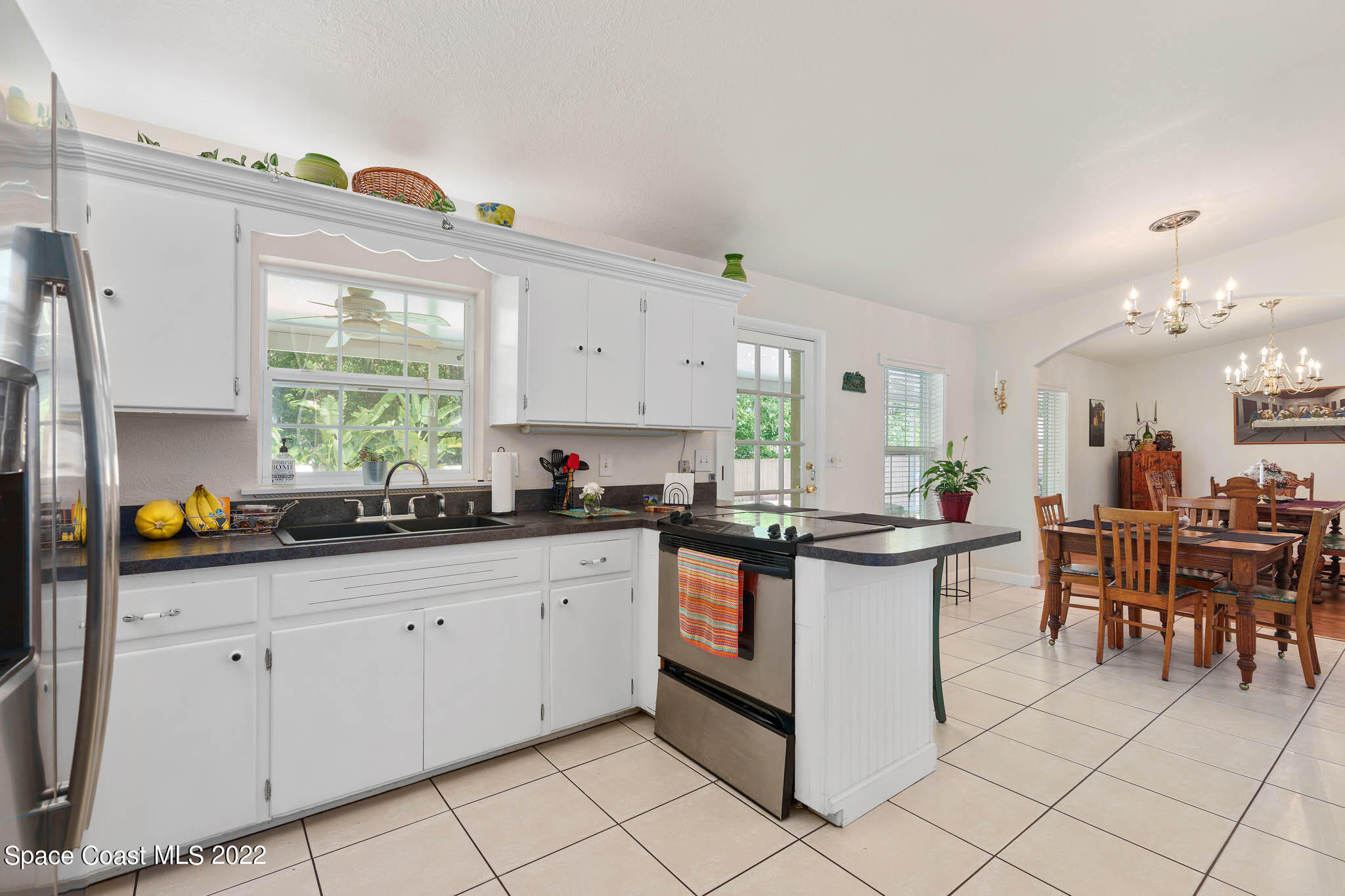 911 Bear Lake Road Apopka, FL 32703 - Photo 8 of 33 a kitchen with stainless steel appliances kitchen island granite countertop a sink and cabinets
