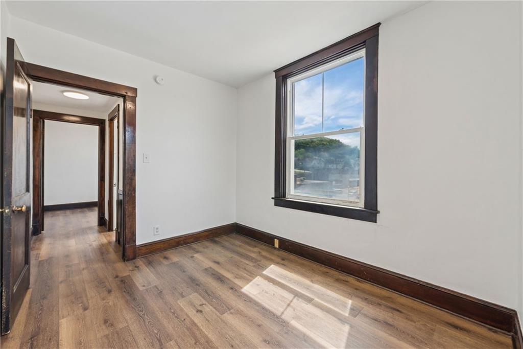 206 North Warren Avenue Apollo, PA 15613 - Photo 11 of 23 a view of an empty room with wooden floor and a window
