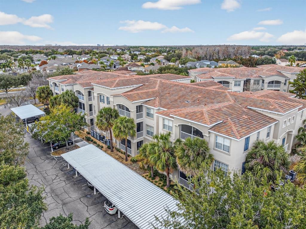 an aerial view of multiple houses with a yard