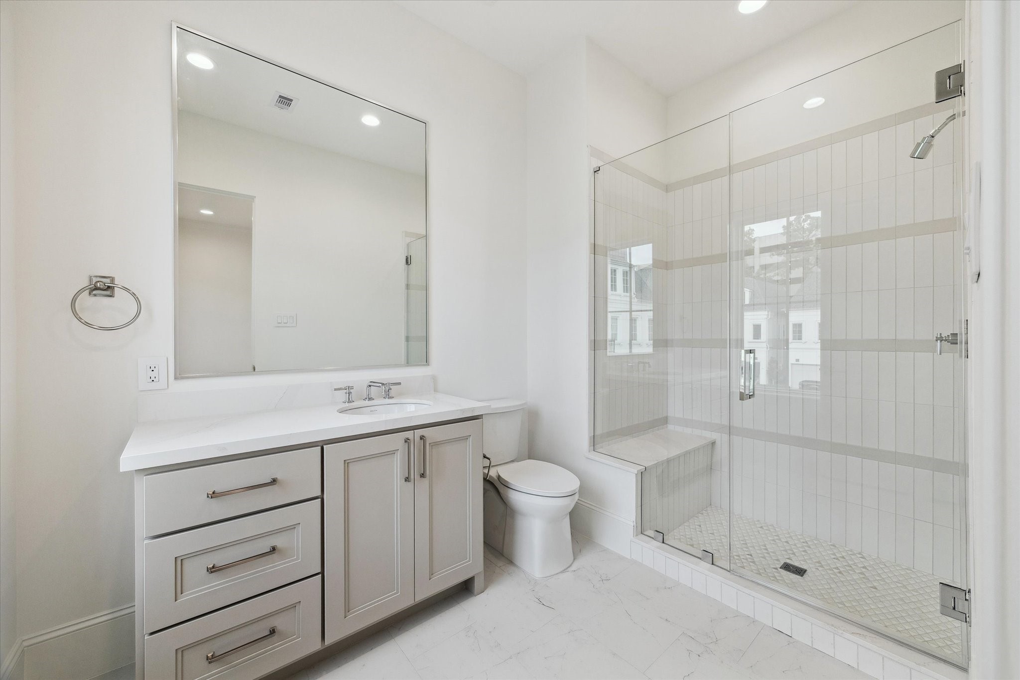 25 Wentworth Gate Path Houston, TX 77027 - Photo 25 of 32 En-suite bathroom features a sleek, glass-encased shower, Quartz counters and additional counter and storage space.