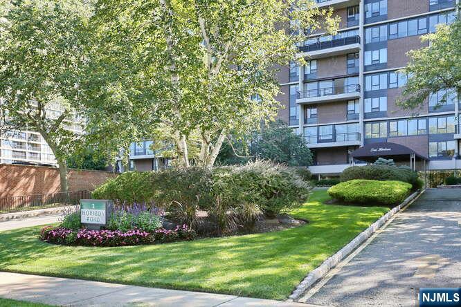 a view of a big house with a big yard and potted plants
