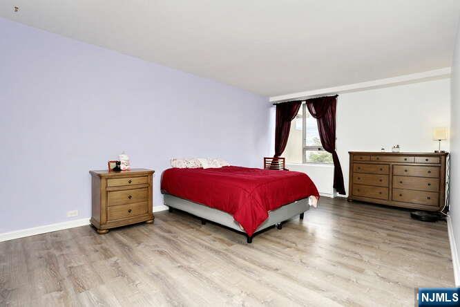 2 Horizon Road, Unit 404 Fort Lee, NJ 07024 - Photo 15 of 30 a bedroom with a bed and a dresser