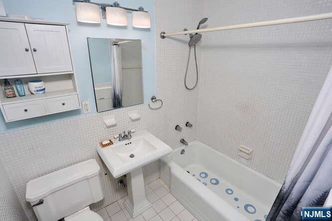 2 Horizon Road, Unit 404 Fort Lee, NJ 07024 - Photo 17 of 30 a bathroom with a sink a toilet and shower