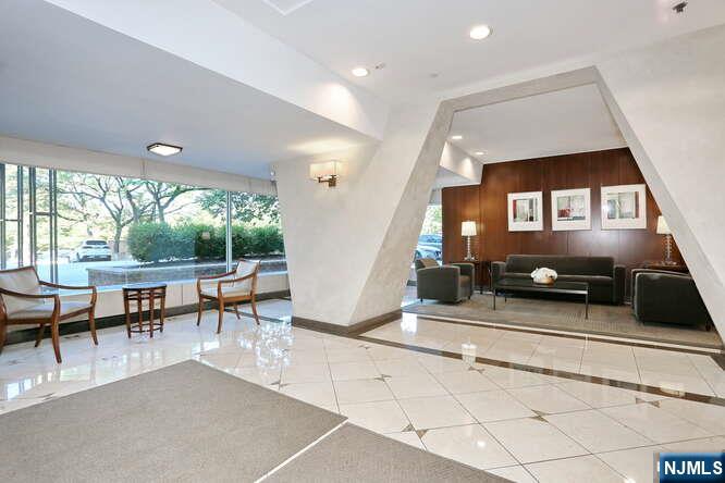 2 Horizon Road, Unit 404 Fort Lee, NJ 07024 - Photo 4 of 30 a living room with furniture a window and a table