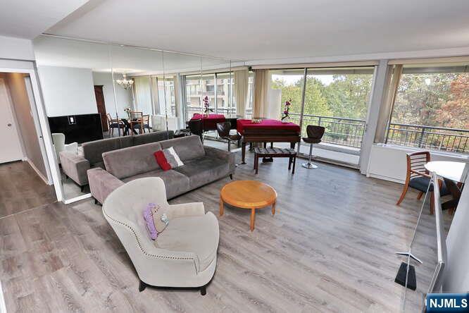 2 Horizon Road, Unit 404 Fort Lee, NJ 07024 - Photo 7 of 30 a living room with furniture a table and large windows