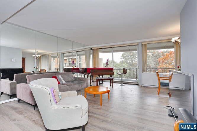 2 Horizon Road, Unit 404 Fort Lee, NJ 07024 - Photo 8 of 30 a living room with furniture and a large window