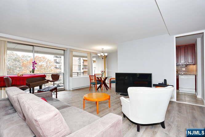 2 Horizon Road, Unit 404 Fort Lee, NJ 07024 - Photo 9 of 30 a living room with furniture and a large window