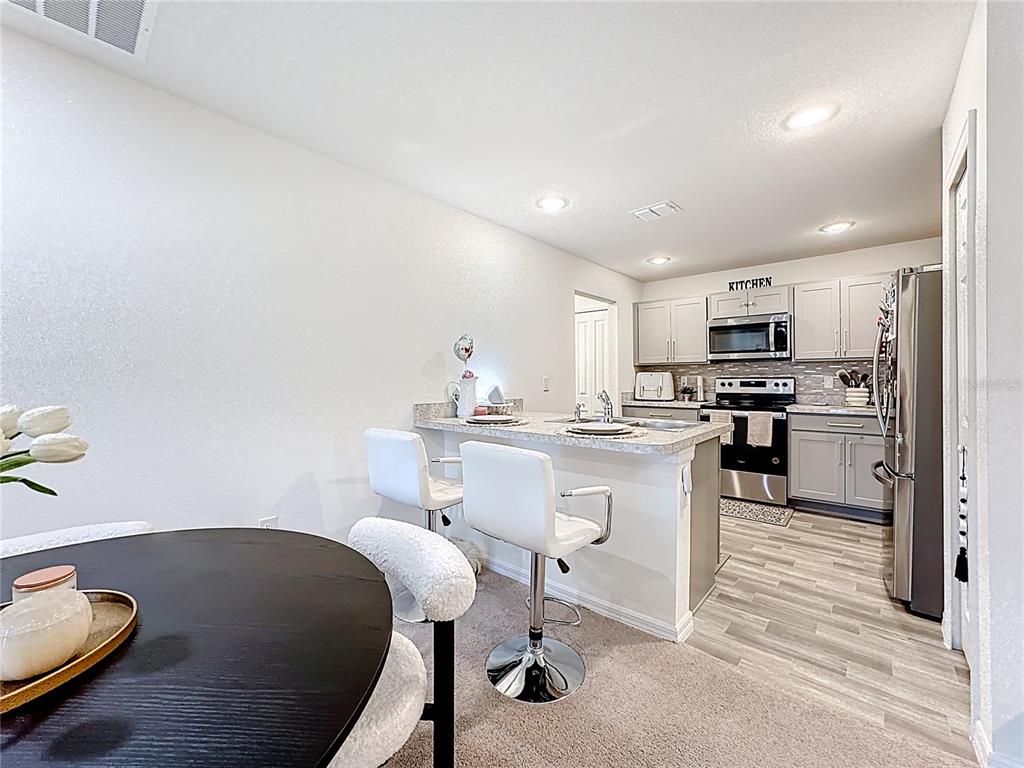 120 Bonito Way Kissimmee, FL 34759 - Photo 12 of 53 a kitchen with granite countertop a sink cabinets and appliances