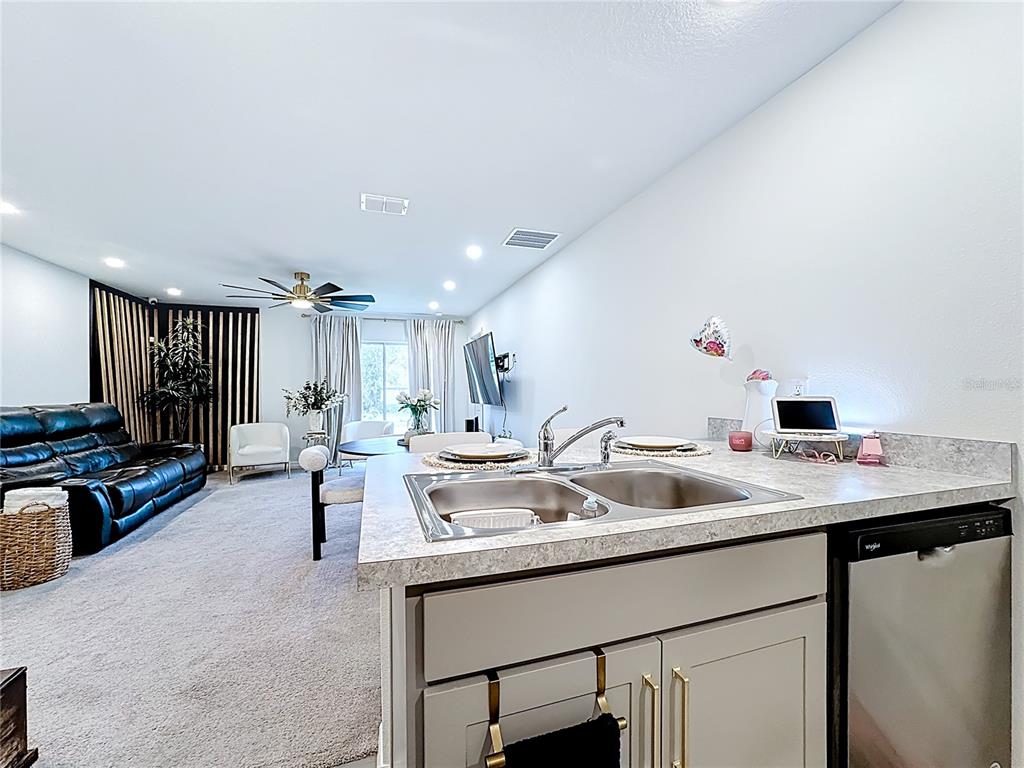 120 Bonito Way Kissimmee, FL 34759 - Photo 16 of 53 a kitchen with a sink and a refrigerator