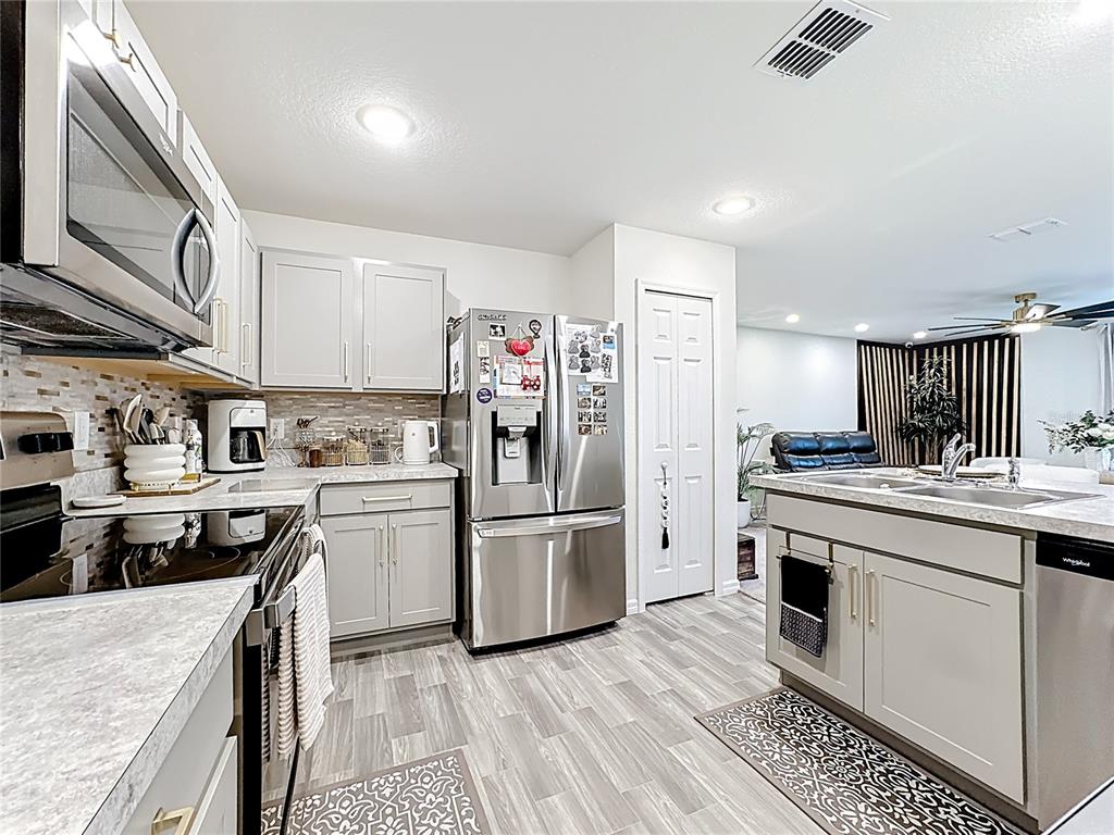 120 Bonito Way Kissimmee, FL 34759 - Photo 17 of 53 a kitchen with a sink stainless steel appliances and cabinets