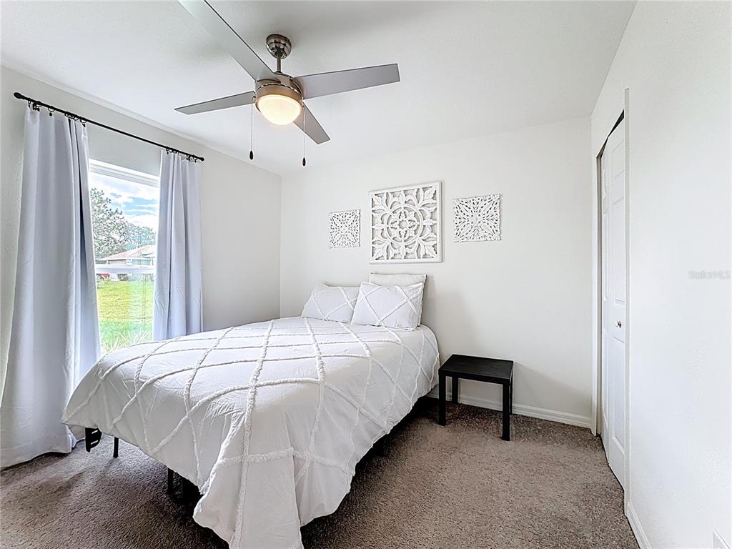 120 Bonito Way Kissimmee, FL 34759 - Photo 19 of 53 a bedroom with a bed and a chandelier