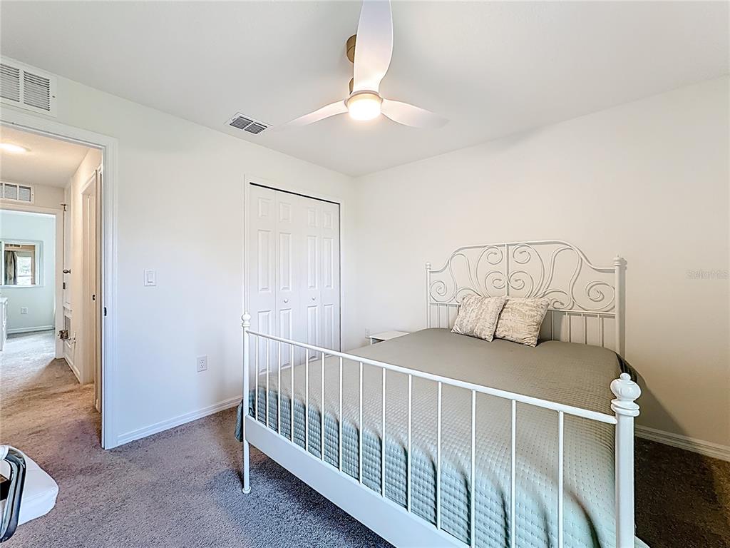 120 Bonito Way Kissimmee, FL 34759 - Photo 21 of 53 a bedroom with a bed and a chandelier fan