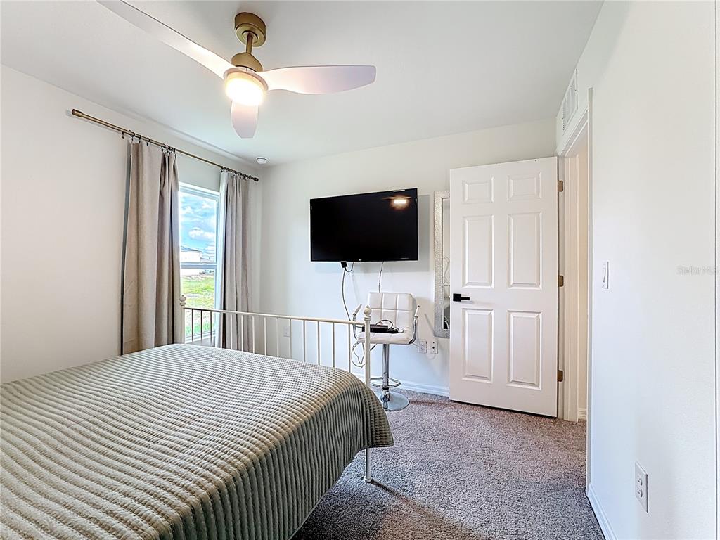 120 Bonito Way Kissimmee, FL 34759 - Photo 23 of 53 a bedroom with a bed tv and a window