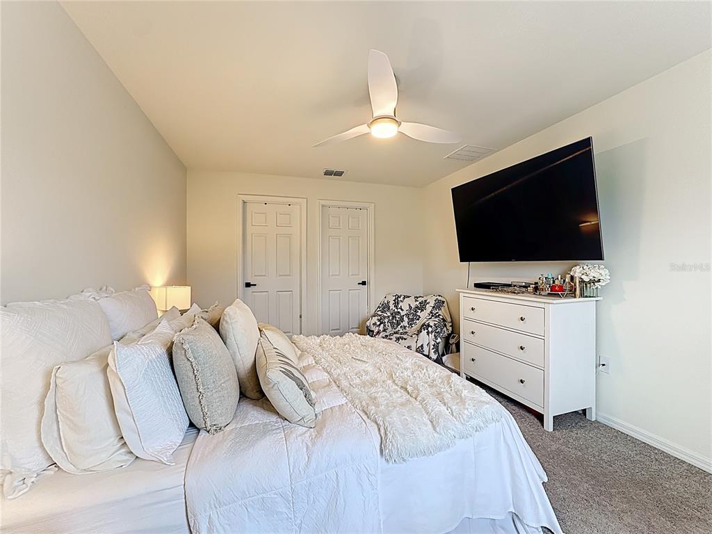 120 Bonito Way Kissimmee, FL 34759 - Photo 25 of 53 a bedroom with a bed and a flat screen tv