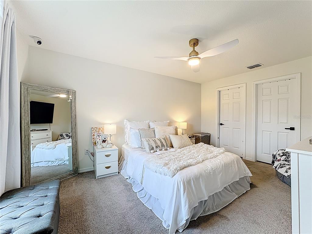 120 Bonito Way Kissimmee, FL 34759 - Photo 26 of 53 a bedroom with a bed and a chandelier