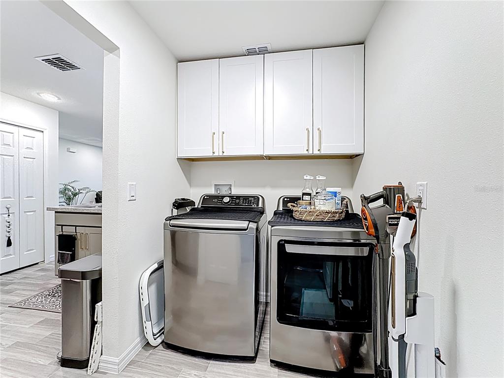 120 Bonito Way Kissimmee, FL 34759 - Photo 31 of 53 a kitchen with stainless steel appliances granite countertop a stove a refrigerator and a microwave