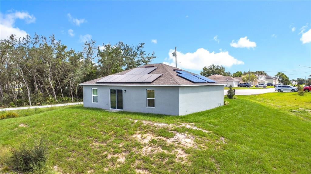 120 Bonito Way Kissimmee, FL 34759 - Photo 35 of 53 a white house with a big yard and large trees