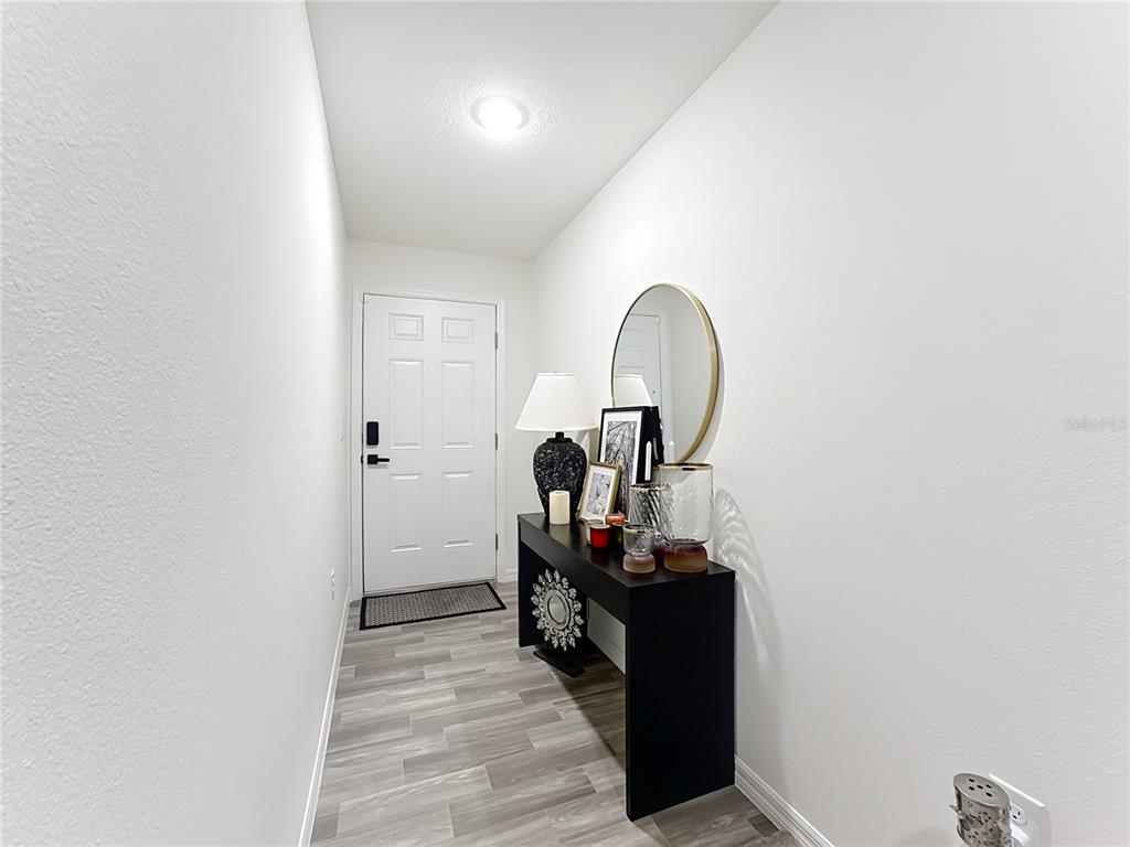 120 Bonito Way Kissimmee, FL 34759 - Photo 5 of 53 a view of a bedroom with wooden floor and furniture