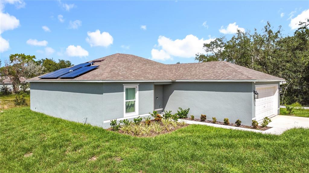 120 Bonito Way Kissimmee, FL 34759 - Photo 52 of 53 a front view of a house with a yard and garage