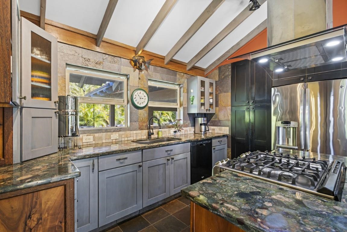 690 East Kuiaha Road Haiku, HI 96708 - Photo 13 of 30 a kitchen with stainless steel appliances granite countertop a sink and wooden cabinets