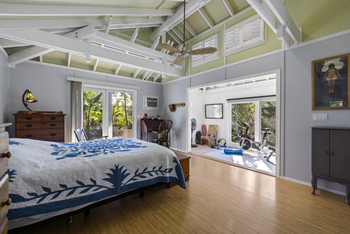 690 East Kuiaha Road Haiku, HI 96708 - Photo 17 of 30 a bedroom with a bed and wooden floor