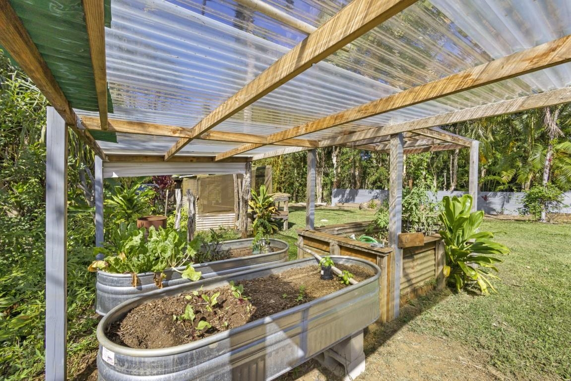 690 East Kuiaha Road Haiku, HI 96708 - Photo 29 of 30 a view of a patio with table and chairs potted plants and large tree