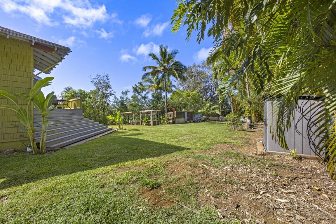 690 East Kuiaha Road Haiku, HI 96708 - Photo 6 of 30 a view of a yard with plants and a palm tree