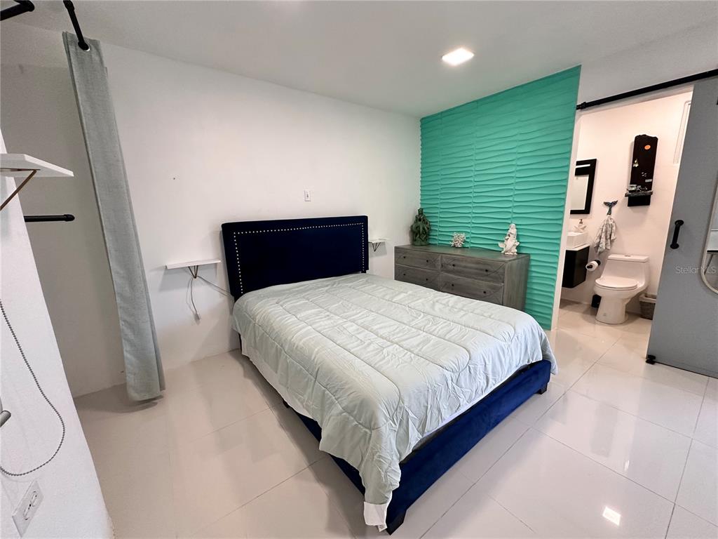 a bedroom with a bed and a mirror