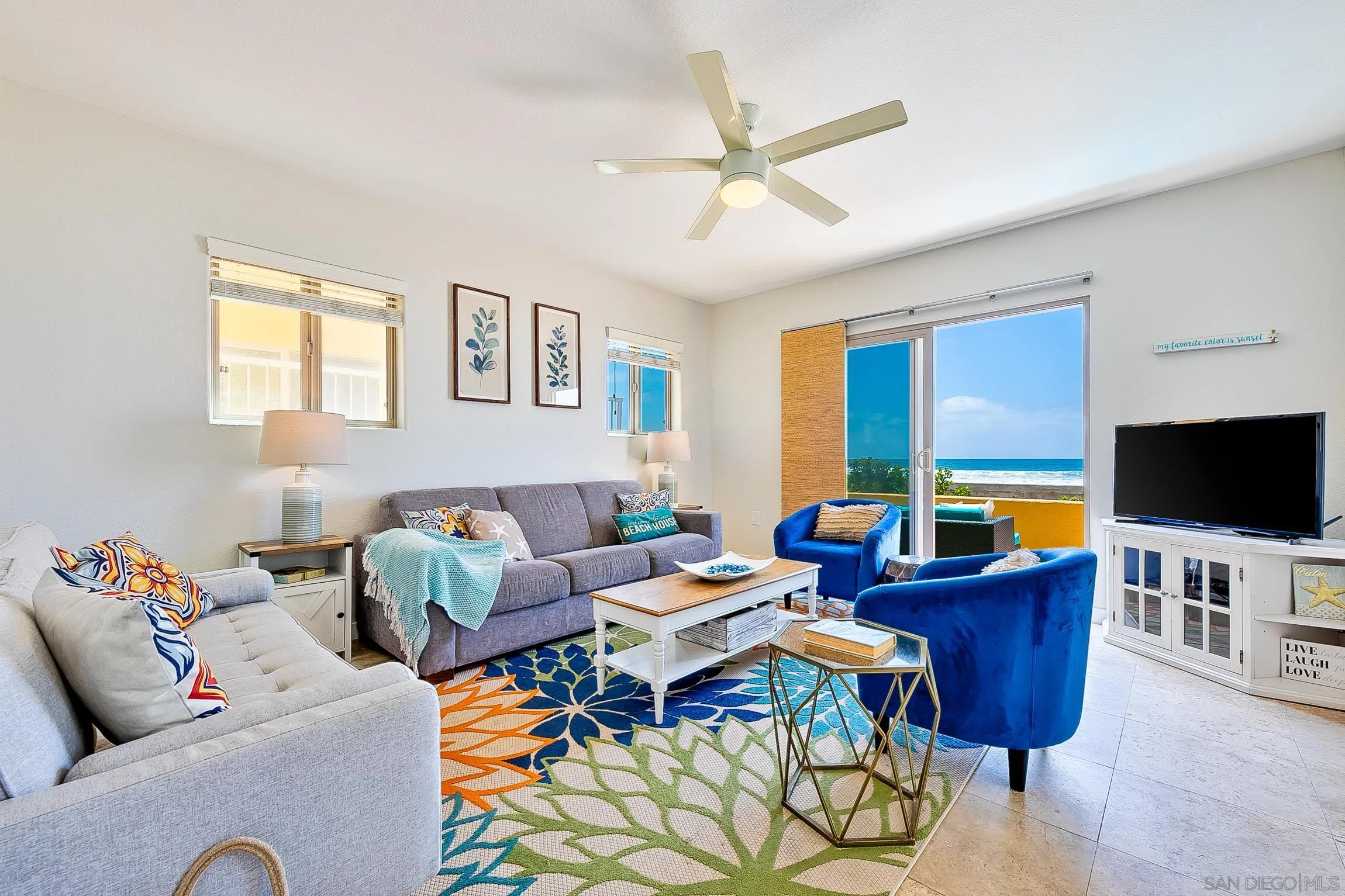 3537 Ocean Front Walk San Diego, CA 92109 - Photo 12 of 51 a living room with furniture a flat screen tv and a window