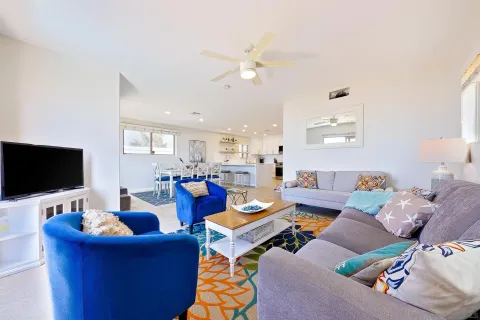 a dining room with furniture a wooden floor and a sink