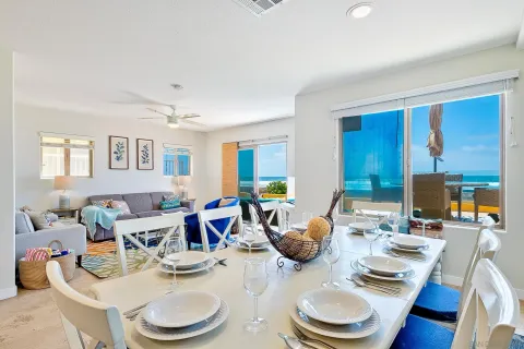 a open kitchen with white cabinets and stainless steel appliances