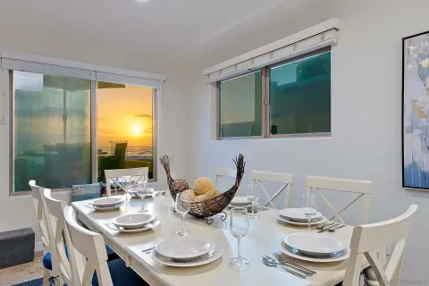 a living room with lots of furniture and view of kitchen