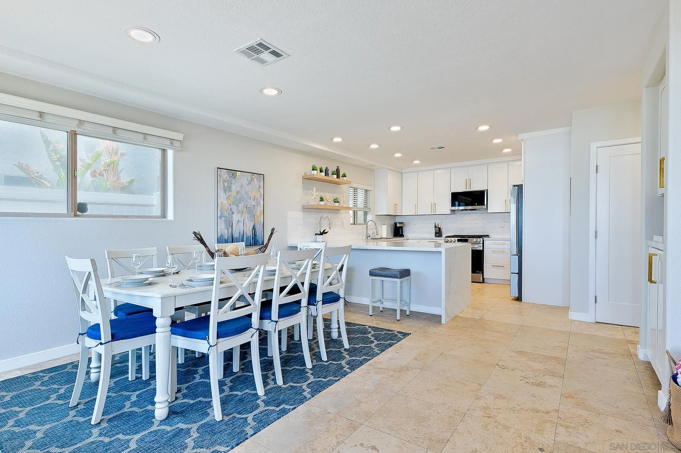 3537 Ocean Front Walk San Diego, CA 92109 - Photo 19 of 51 a open kitchen with white cabinets and stainless steel appliances