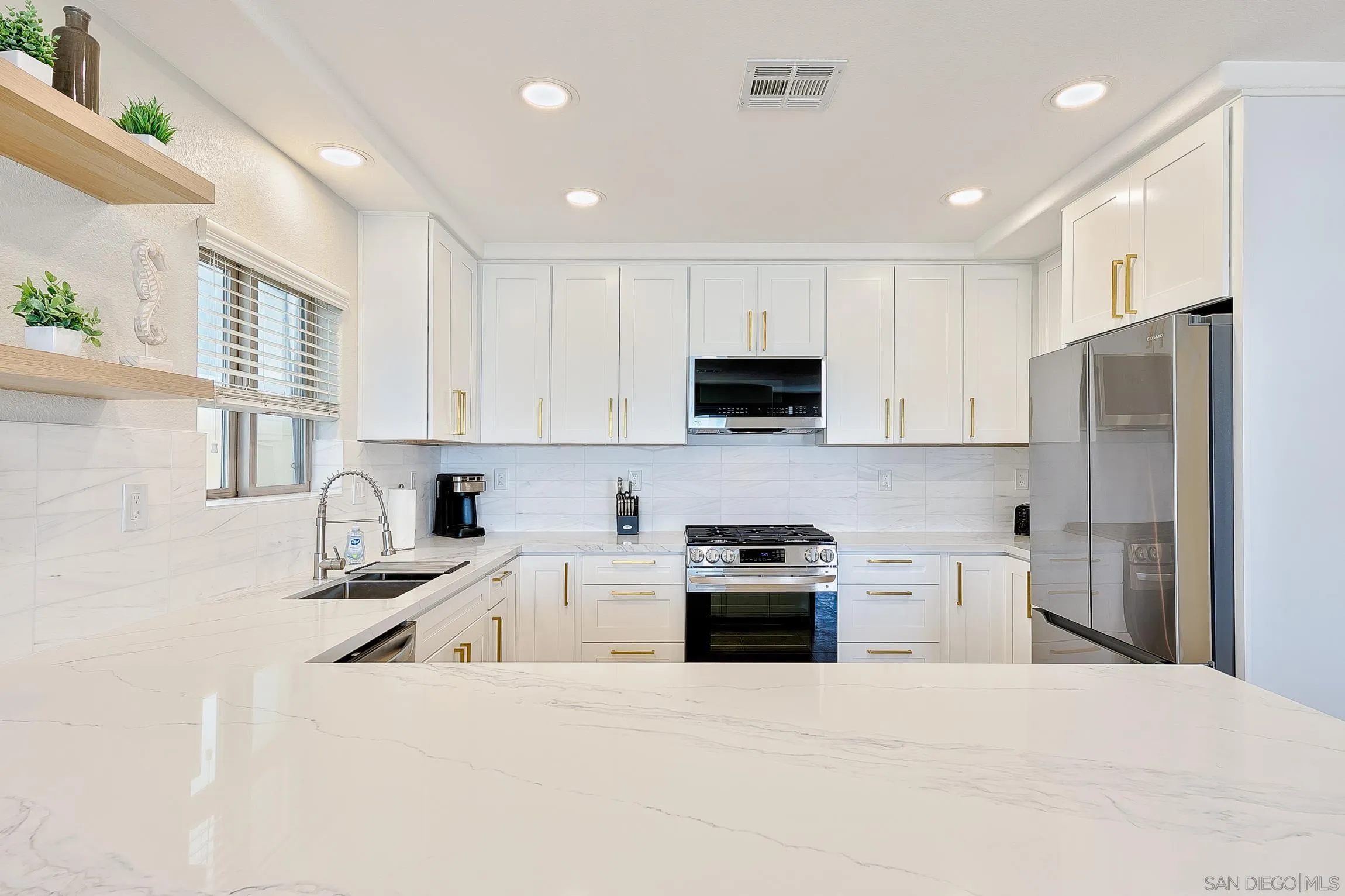 3537 Ocean Front Walk San Diego, CA 92109 - Photo 22 of 51 a kitchen with stainless steel appliances granite countertop a refrigerator sink and stove