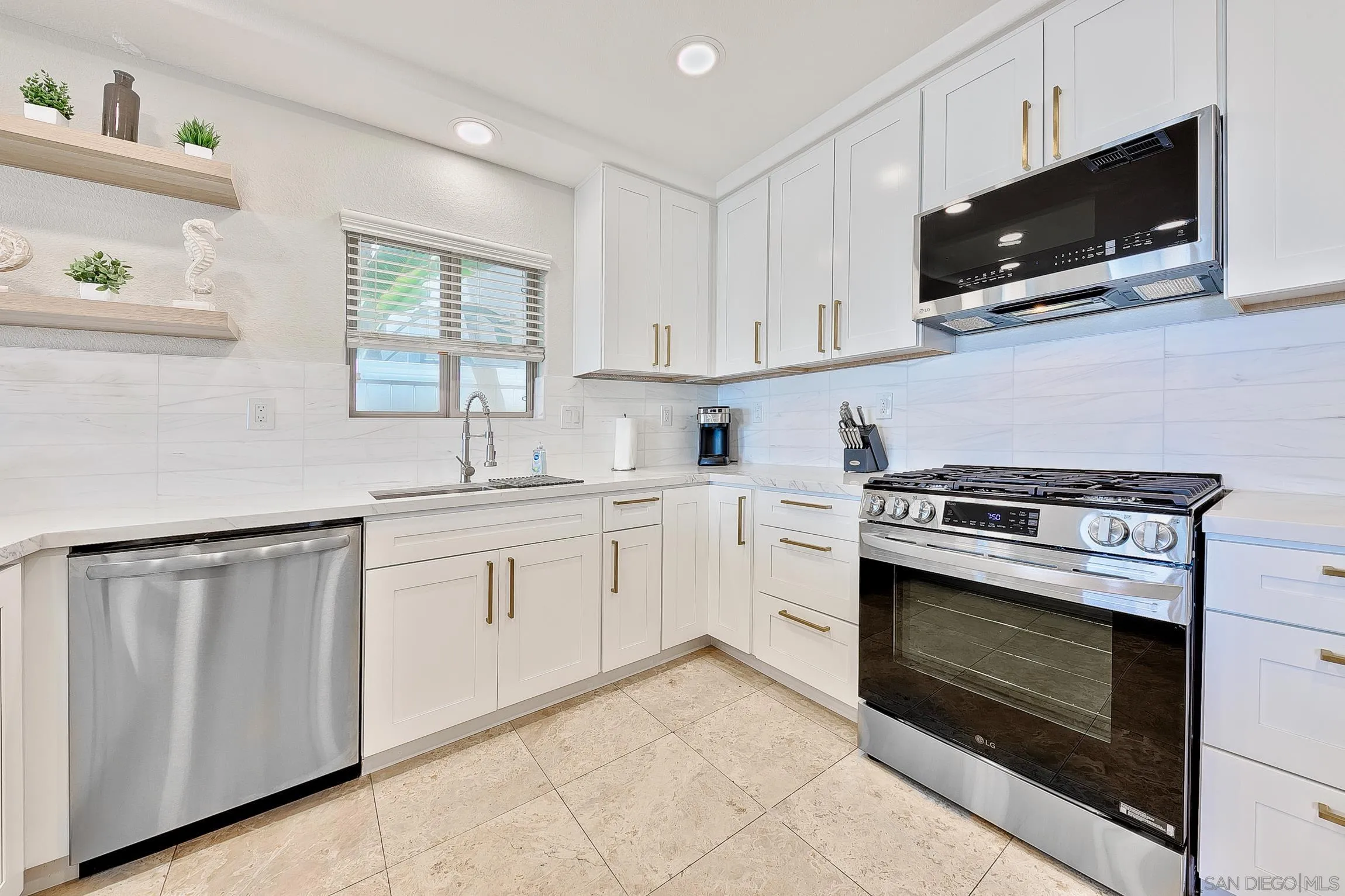 3537 Ocean Front Walk San Diego, CA 92109 - Photo 24 of 51 a kitchen with white cabinets stainless steel appliances and sink