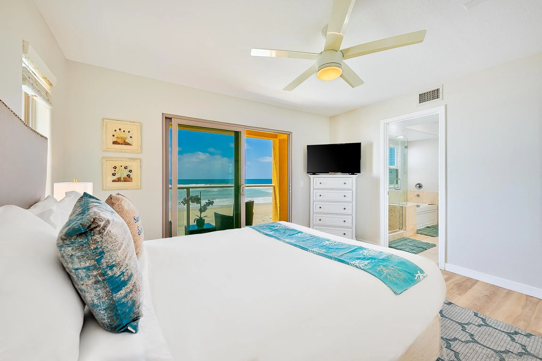 3537 Ocean Front Walk San Diego, CA 92109 - Photo 29 of 51 a bedroom with a large bed and a flat tv screen on dresser