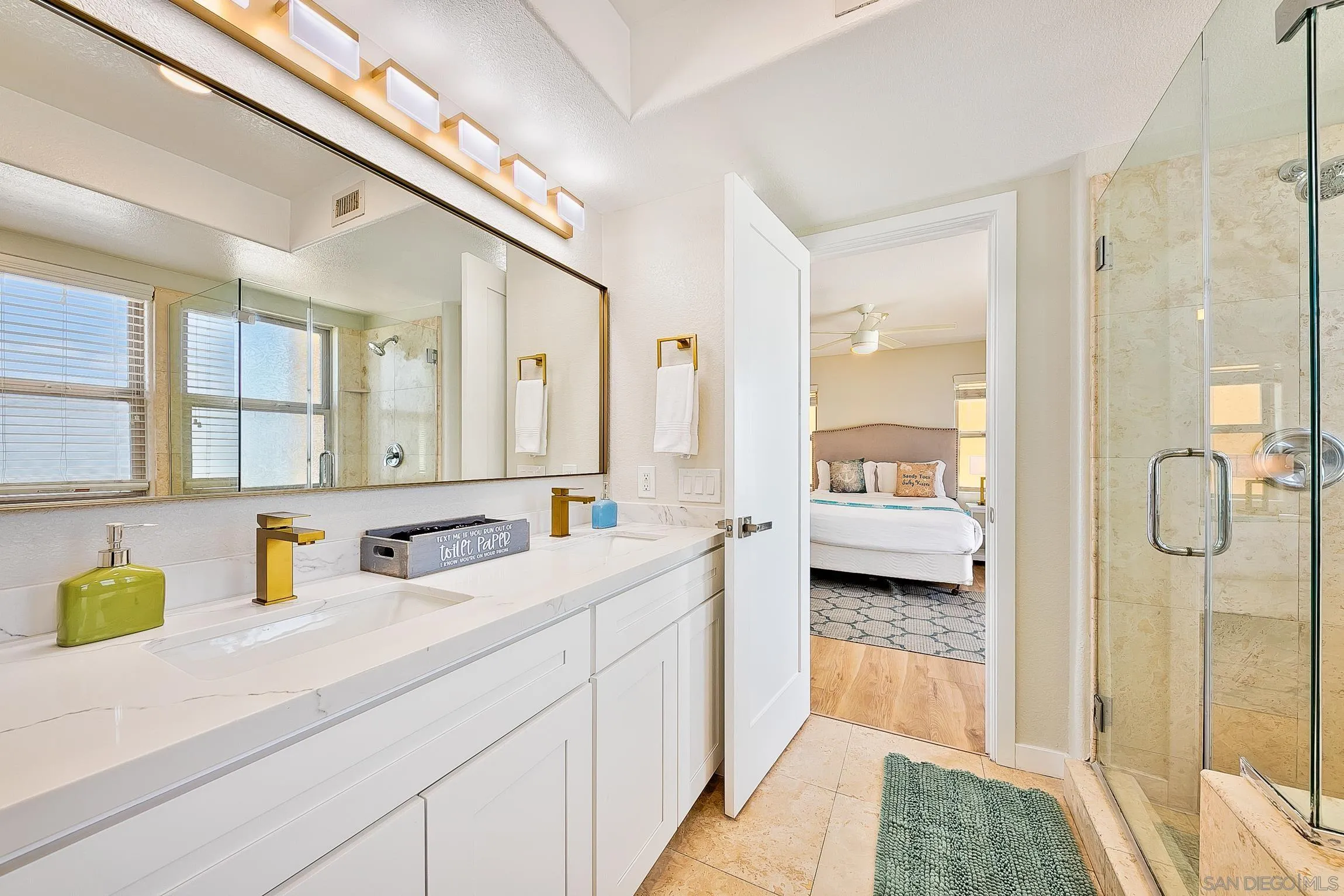 3537 Ocean Front Walk San Diego, CA 92109 - Photo 39 of 51 a en suite bathroom with a granite countertop sink and mirror