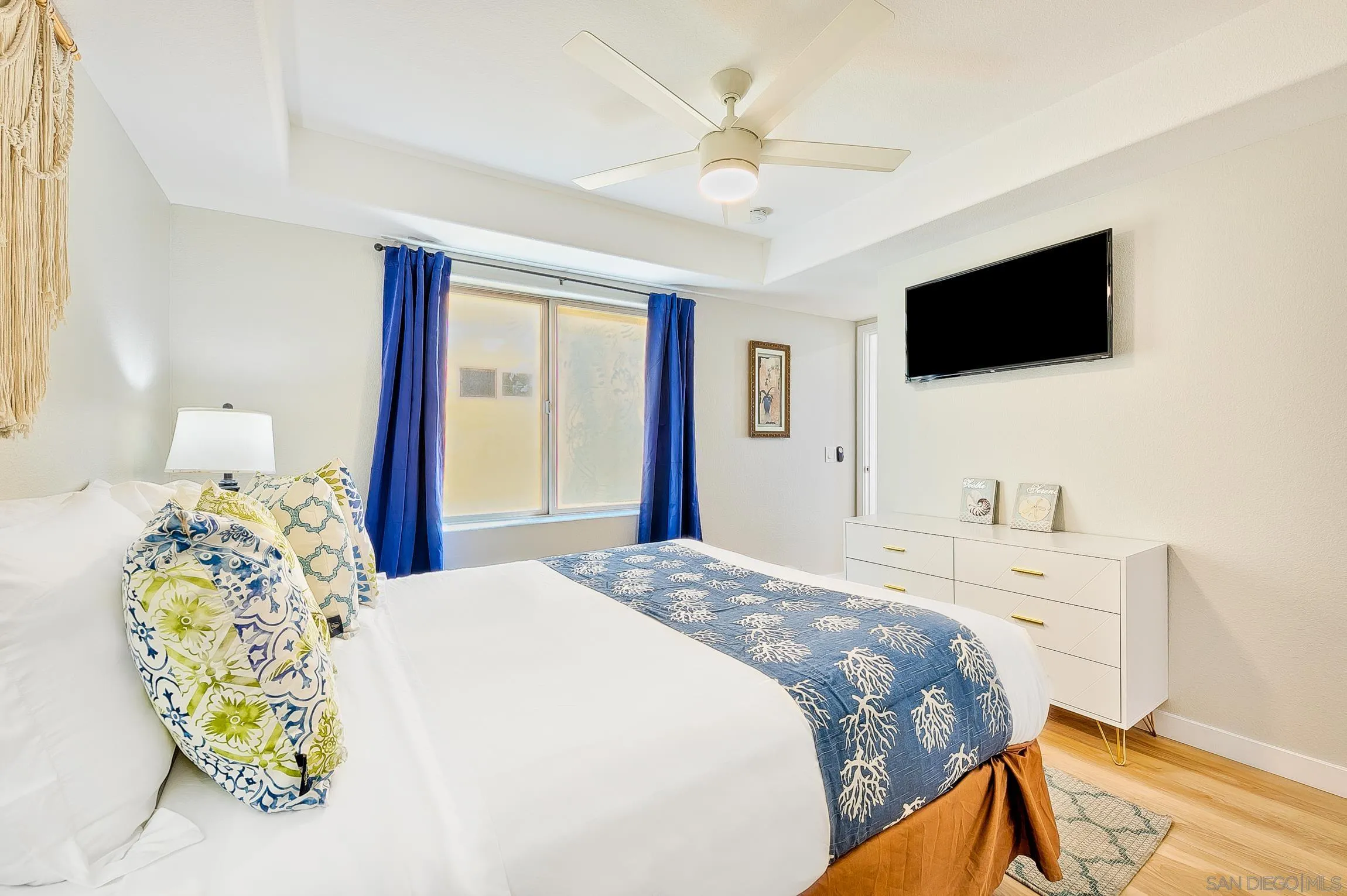 3537 Ocean Front Walk San Diego, CA 92109 - Photo 41 of 51 a spacious bedroom with a bed and a flat screen tv