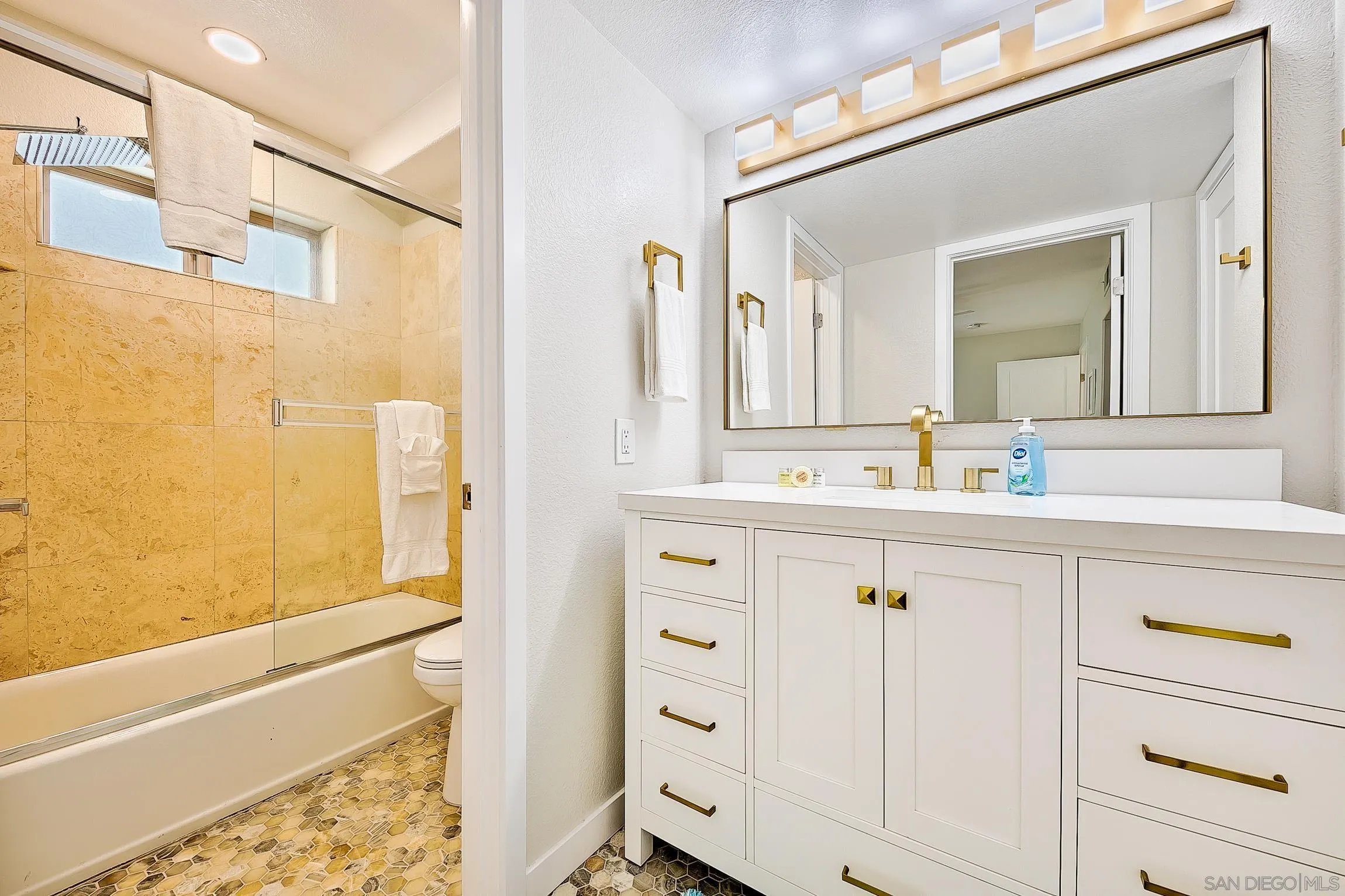 3537 Ocean Front Walk San Diego, CA 92109 - Photo 43 of 51 a bathroom with a sink a mirror and a bathtub