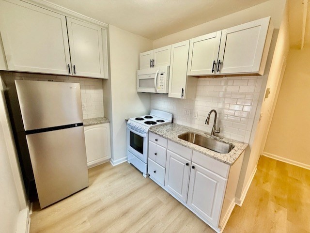 7 Tileston Street, Unit 2 Boston, MA 02113 - Photo 4 of 12 a kitchen with white cabinets and white appliances