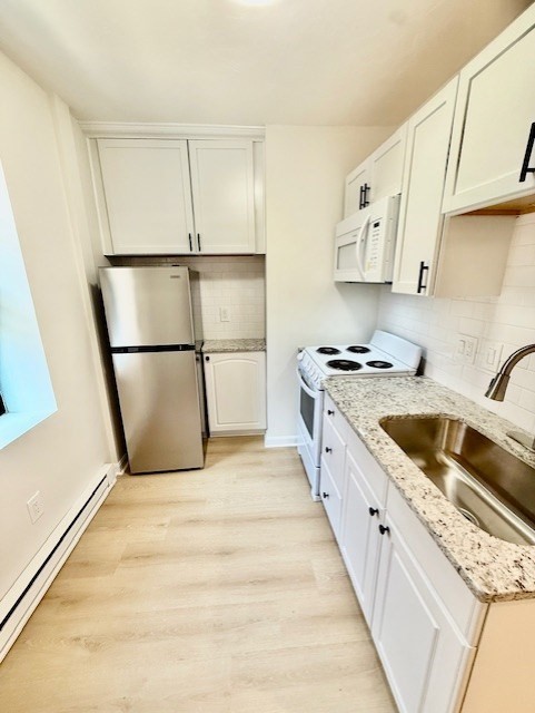 7 Tileston Street, Unit 2 Boston, MA 02113 - Photo 5 of 12 a kitchen with granite countertop a sink and a refrigerator