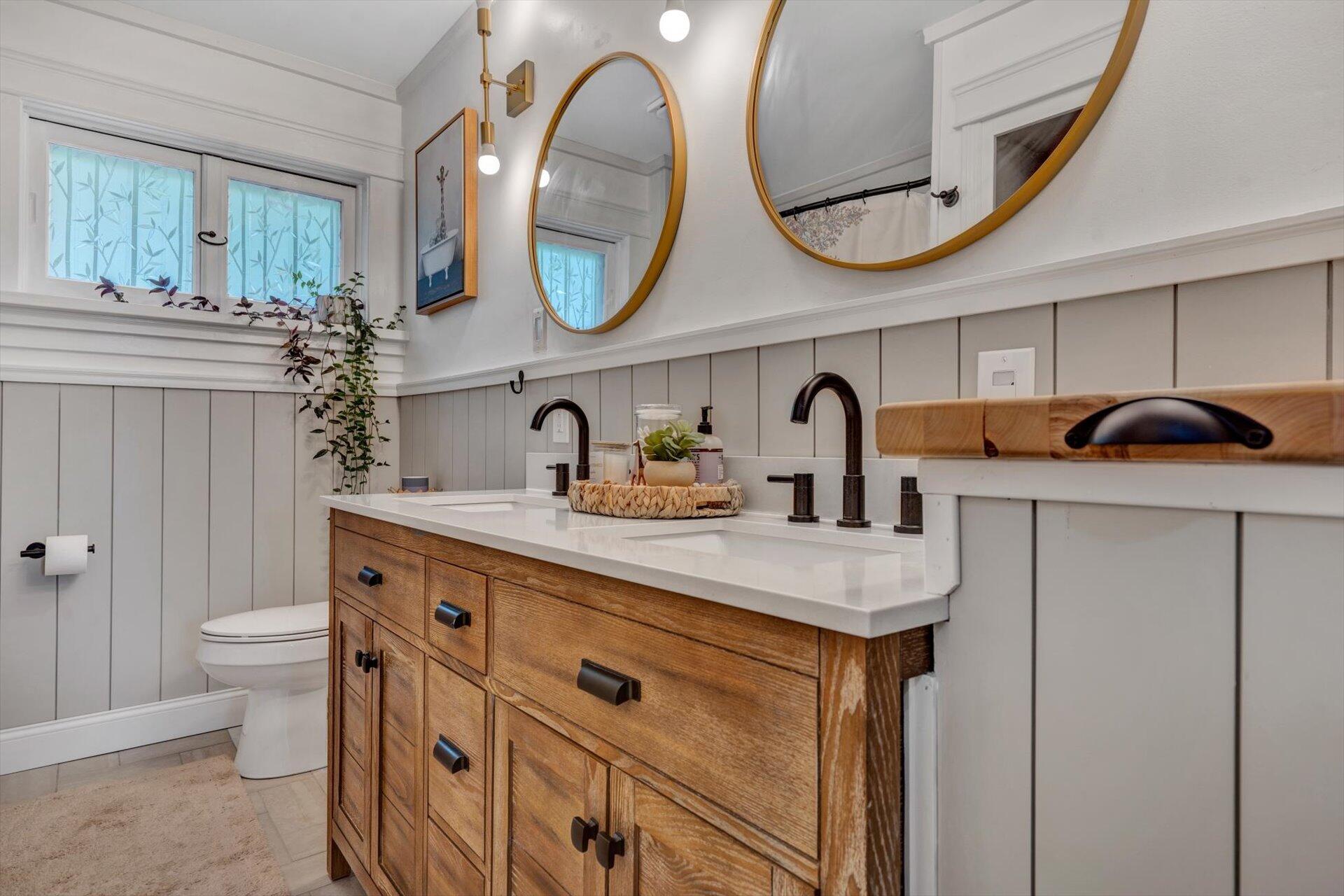 3038 Burnleigh Road Southwest Roanoke, VA 24014 - Photo 22 of 34 a bathroom with a granite countertop sink a mirror and a toilet